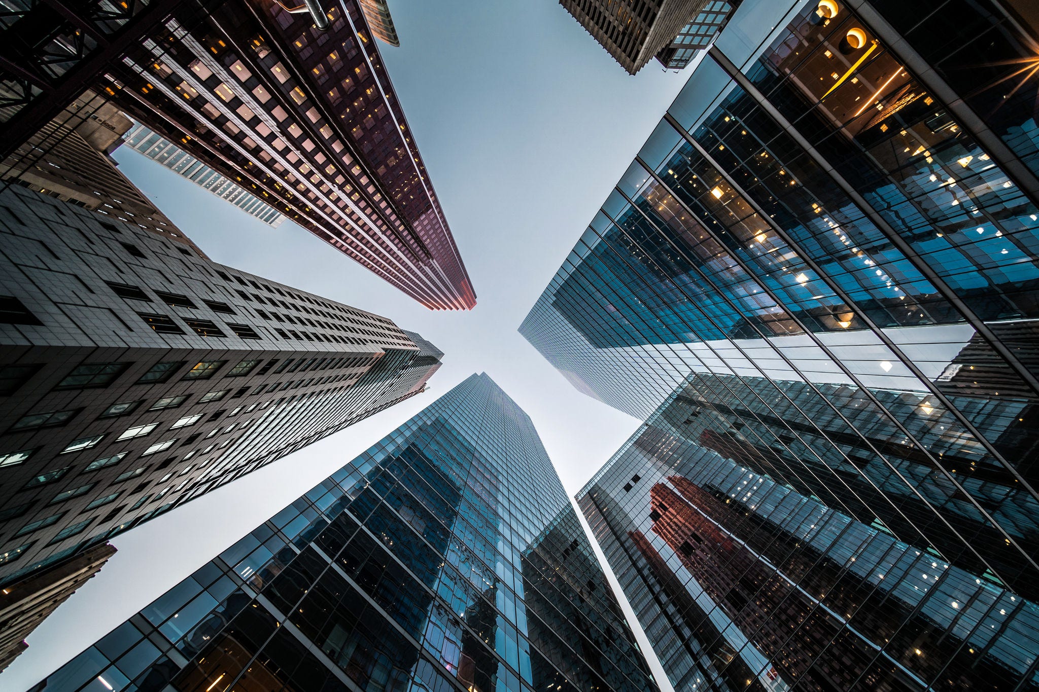 Business and finance concept, looking up at high rise office building architecture in the financial district of a modern metropolis.