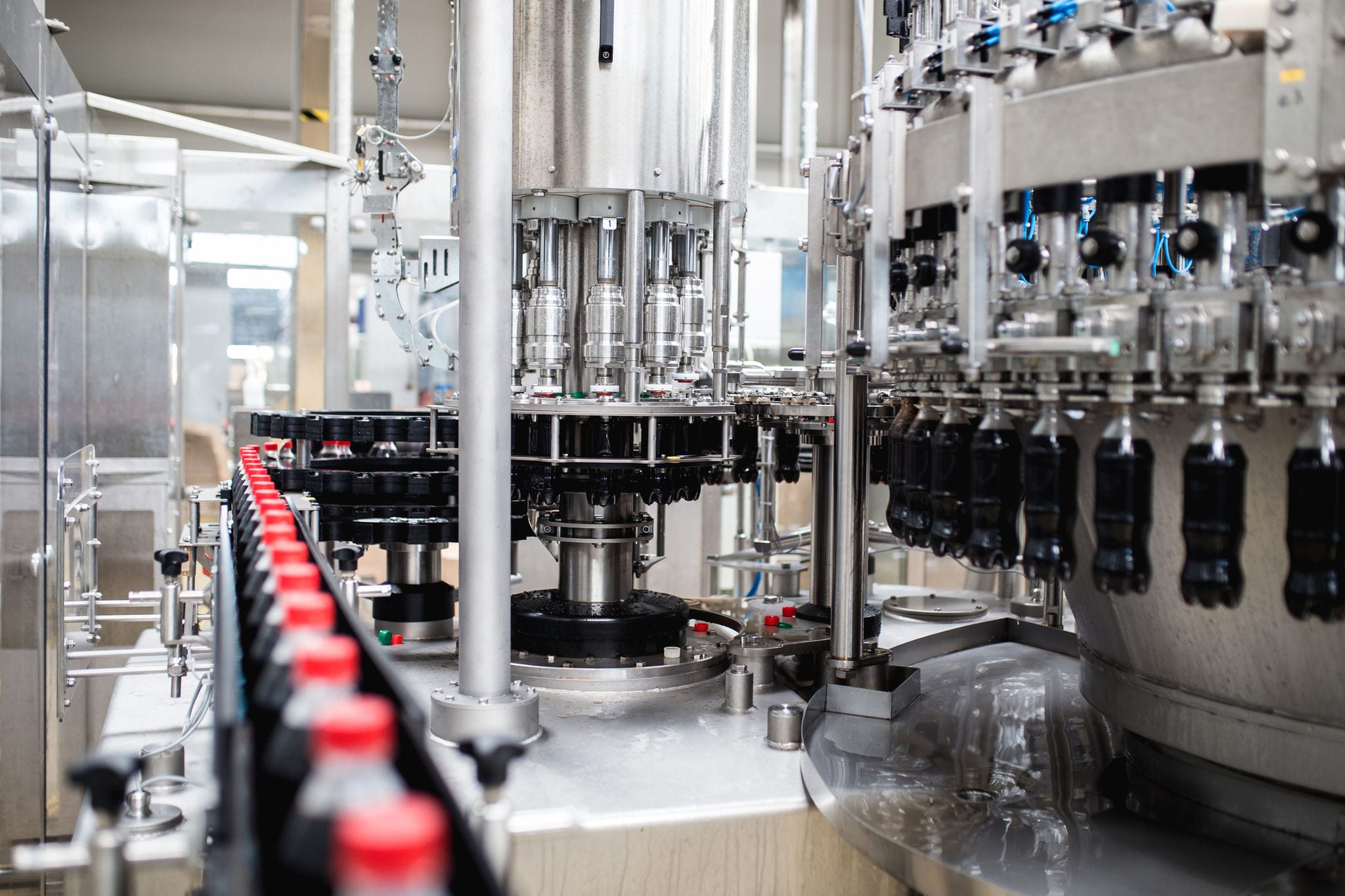 Water bottling line for processing and bottling black carbonated juice into bottles.