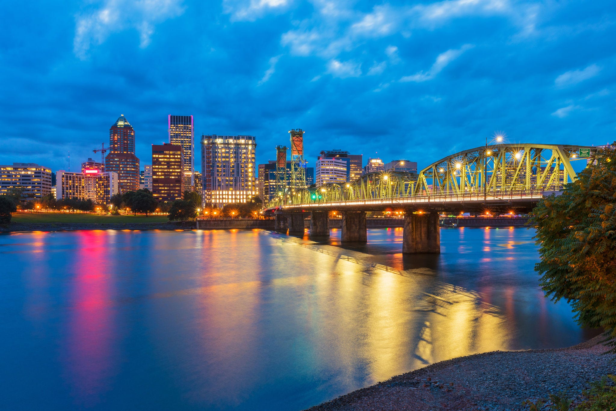Skyline of Portland, Oregon, USA at dusk, with Willamette River and Hawthorne Bridge.