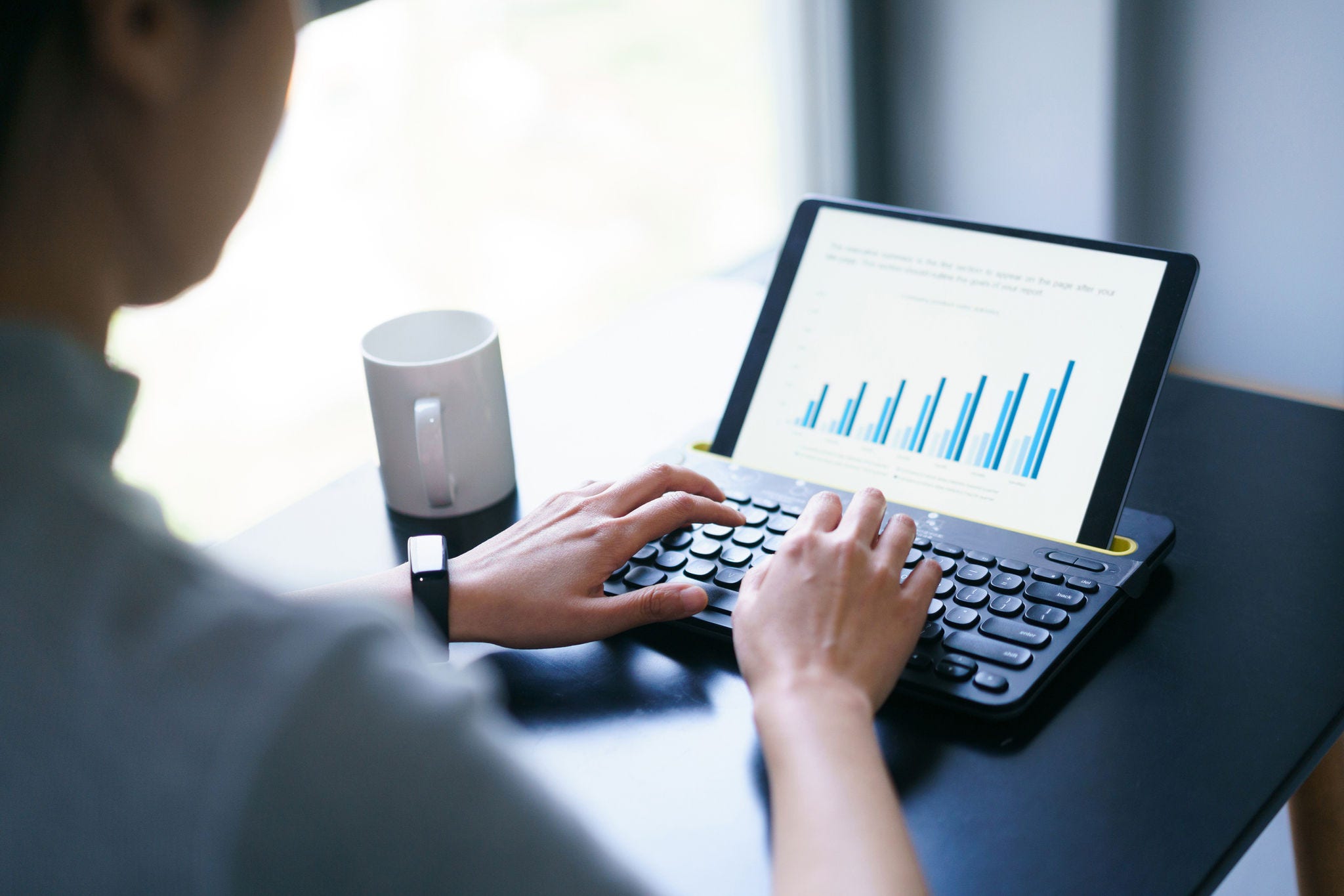 asian business woman working with business report on digital tablet